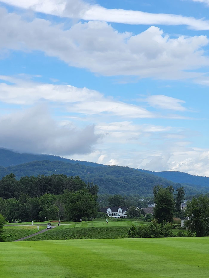 Panoramic view of a golf course with the Blue Ridge Mountains in the background in Crozet, VA