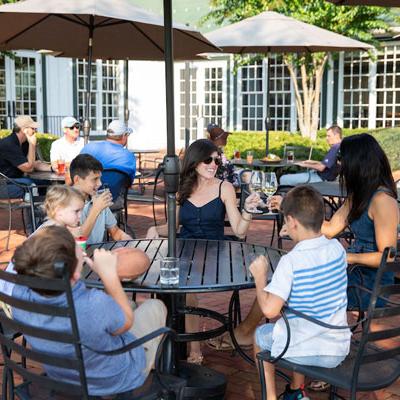 A family savoring wine together at a winery, enjoying a delightful breakfast in Crozet, VA